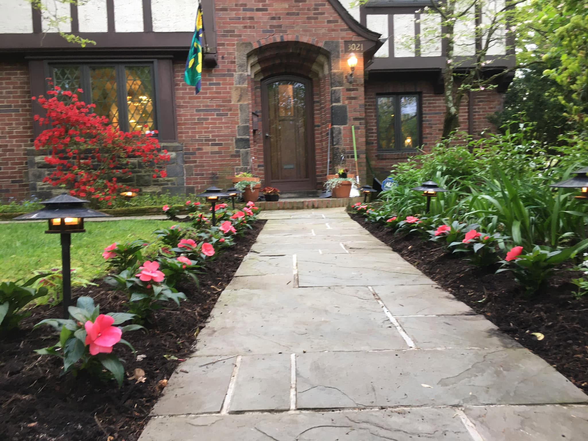 Real stone paver walkway with mulched garden beds and a Japanese maple, installed by Old Allegheny Landscaping